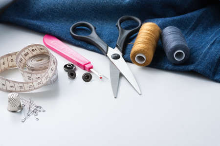 Sewing Tools And Jeans Fabric On White Table With Copyspace.の写真素材