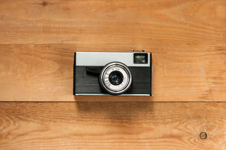 Vintage Old Retro Camera On Wooden Brown Board Top View And Copyspace.