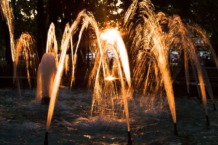 Water Fountain At Sunset In Evening In Park.の写真素材