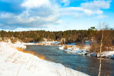 Beautiful Scenic Landscape View In Russia Of River Under Dramatic Sky With Clouds In Sunny Day In Winter. Woods Forest On Riverside.の写真素材
