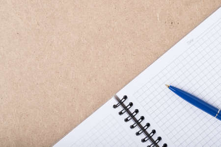 Empty Notebook In Grid With Pen On Wooden Board Background Close Up.の写真素材