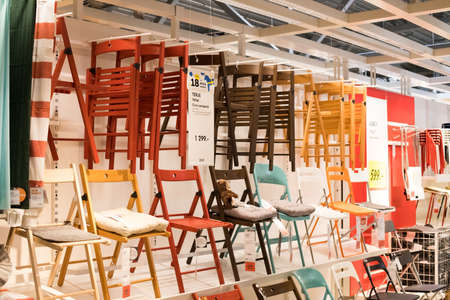Moscow, Russia - March 25, 2018: Sample Of Interior Of Modern Design Of Variety Colorful Folding Chairs Display On Shelf In Shop IKEA.のeditorial素材