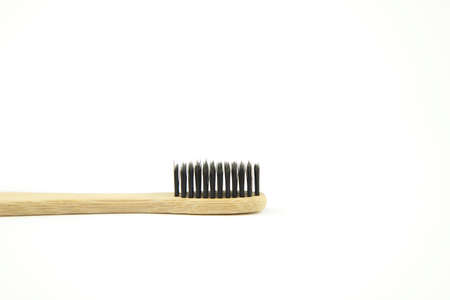 bamboo ecological toothbrush on a white background. Caring for the environment. Zero waste. Oral and...