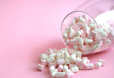 white and pink marshmallows in a glass cup. marshmallows in a glass gobletの写真素材