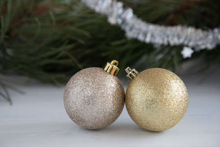 New Year's toys, two christmas tree balls on a white wooden table. New Year concept. Place for textの写真素材