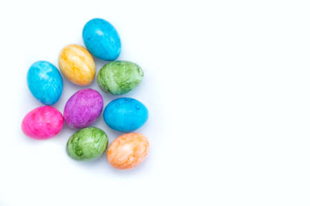 Multi-colored eggs on a white background. Orange, blue, green and pink eggs. Easterの写真素材