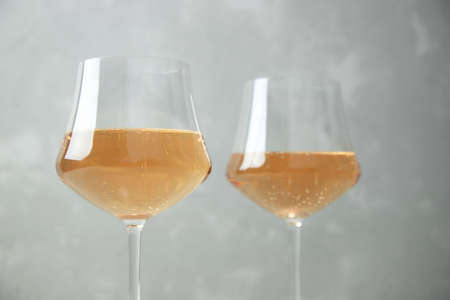 Two glasses of orange wine with glass goblets on a gray background.の写真素材