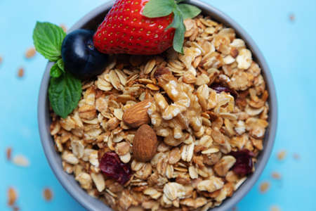 Close-up on granola, granola with fresh strawberries, blueberries and nuts. Proper nutrition, diet. Granola home do-it-yourself.の写真素材