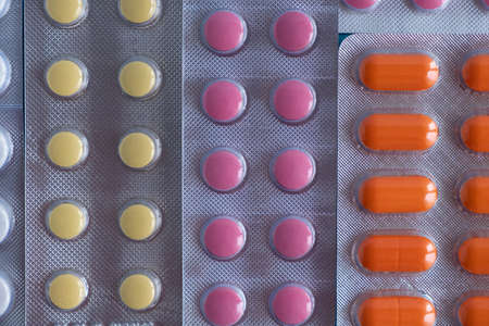 Packaging, blisters with multi-colored tablets, pills, antibiotics. Background or texture on a medical themeの写真素材