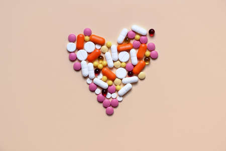 Medical concept. Assorted pharmacological preparations, tablets and pills in the shape of a heart. Treatment with pills. Place for text.の写真素材