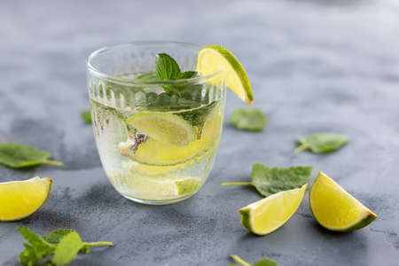 A refreshing, summer drink with limemy ice and mint. Lemonade with an eco straw. Relaxing non-alcoholic or alcoholic cocktailsの写真素材