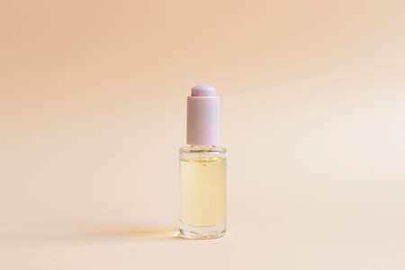 A bottle of collagen or hyaluronic acid on a neutral background with space for text. Cosmetic skin...