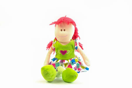 Soft plush multicolored toy doll on a white background. Educational toys. Sleep toys.の写真素材