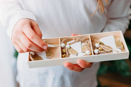 Close-up on a box with wooden ecological toys for the Christmas tree. Eco-friendly New Year and Christmas. Trending Christmas tree decorations.の写真素材