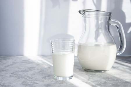 Homemade fermented drink kefir or ayran or milk. Trending shadow photography. Healthy bowel concept. Healthy food, breakfastの写真素材