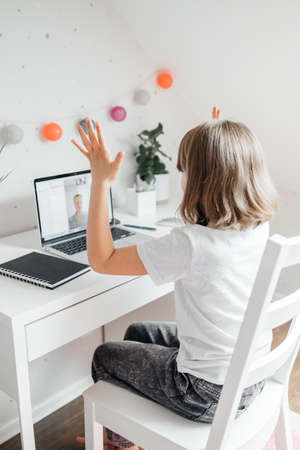 Girl teenager communicates online, makes a video call using a laptop. Learning and communicating...