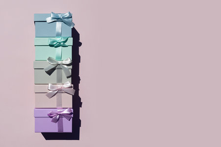 Top view of colorful gift boxes tied with ribbons on pink background. Place for text. Black Friday