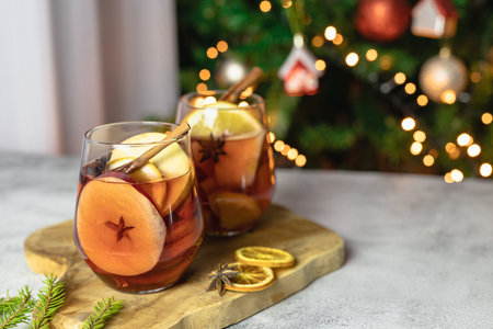 Glasses of hot freshly brewed mulled wine with pieces of fresh fruit. Traditional winter drinkの写真素材