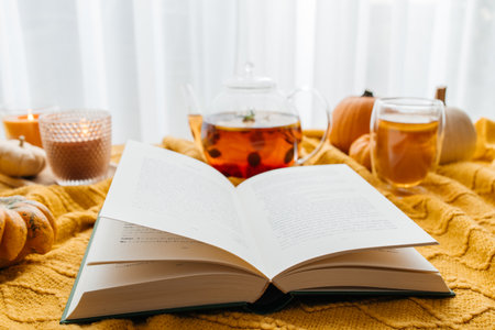 Cozy autumn reading with hot tea and pumpkinsの写真素材