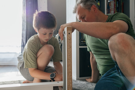 Father and son assembling furniture together, family bondingの写真素材