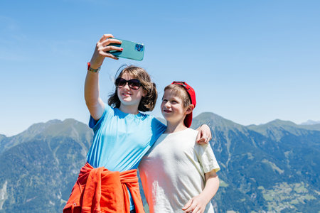 Hikers taking selfie with smartphone in mountain landscape