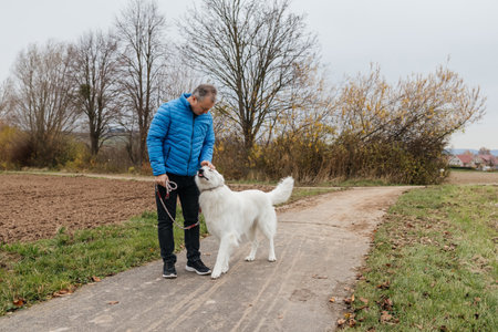 Man enjoying walking and petting his white dog