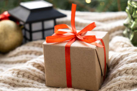 Christmas gift box. Xmas and Happy New Year background, close up. Gift with red ribbon. Celebrating...