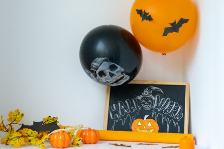 Preparation for Halloween party at home. Room is decorated with pumpkin, balloons, bats and candles. holiday decoration conceptの写真素材