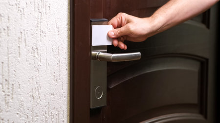 Male hand open hotel room door with electronic card key. Magnetic smart key to unlock doors....