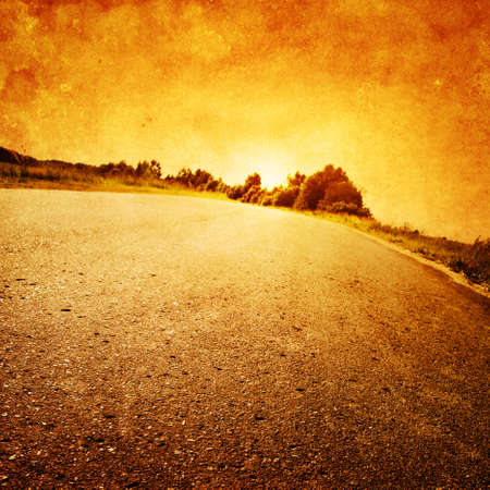 Grunge image of road at sunset の写真素材
