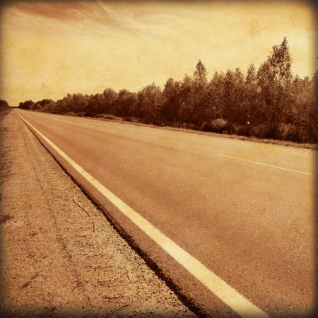 Old style photo of empty asphalt road の写真素材
