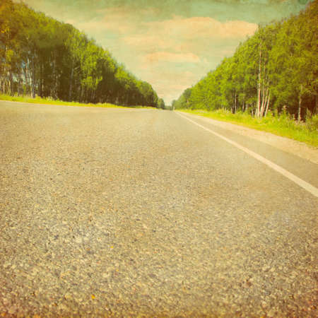 Country asphalt road in grunge and retro style の写真素材