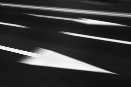 Asphalt road in motion blur with arrow.の写真素材
