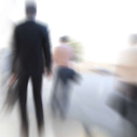 Motion blurred business people walking in the city の写真素材