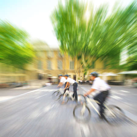 Police officers on bicycles in motion blur の写真素材