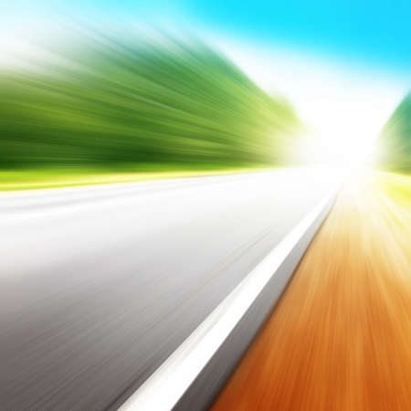 Country asphalt road in motion blur and sunlight.の写真素材