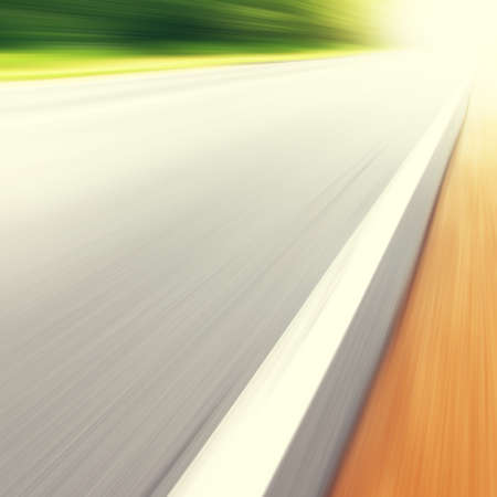 Country asphalt road in motion blur and sunlight.の写真素材