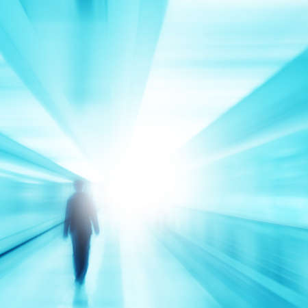 Toned blurred image of blurred man walking to light.の写真素材