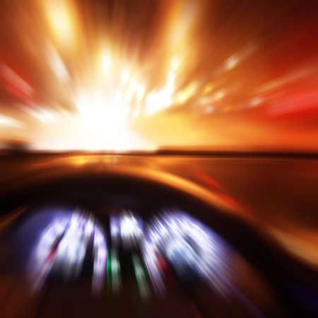 Car driving fast at sunset. Blurred motion image.の写真素材