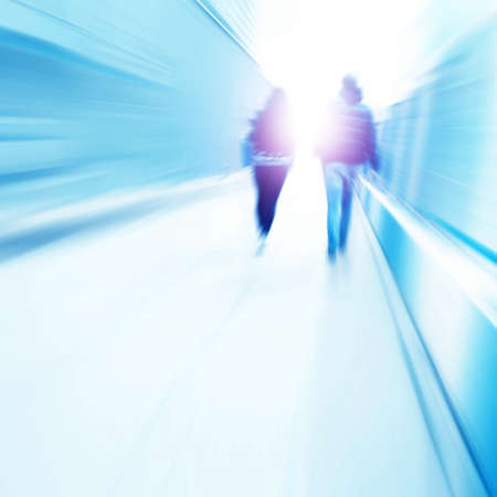 Toned image of motion blurred people walking to light.の写真素材