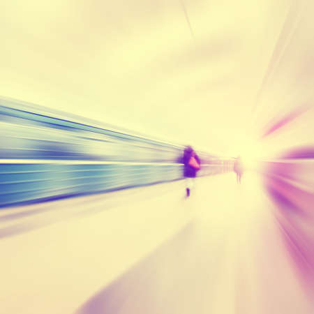 Train in motion blur and blurred people in subway station. Vintage style.の写真素材