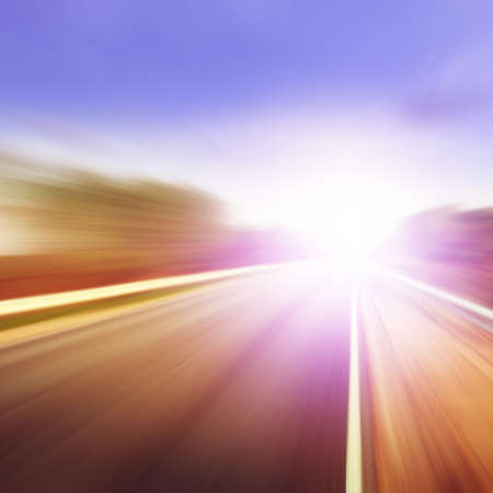 Country asphalt road in motion blur at sunset.