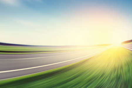 Motion blurred road and dramatic sunset.の写真素材