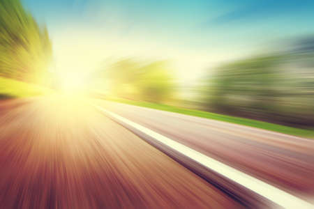 Country asphalt road in motion blur at sunset.の写真素材