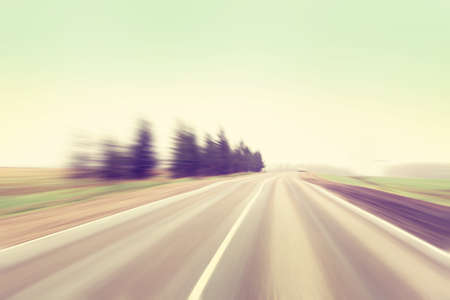 Motion blurred country road in vintage color.の写真素材