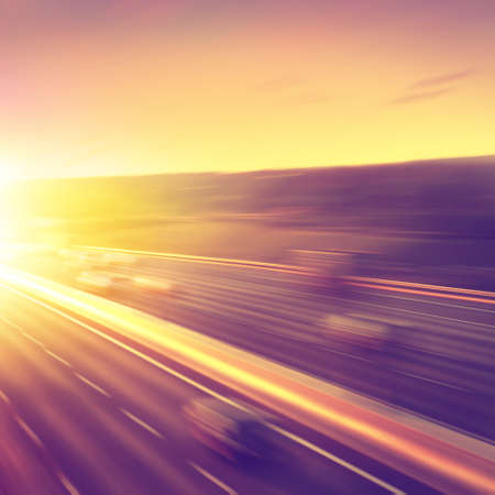 Motion blurred cars on highway during sunset.の写真素材