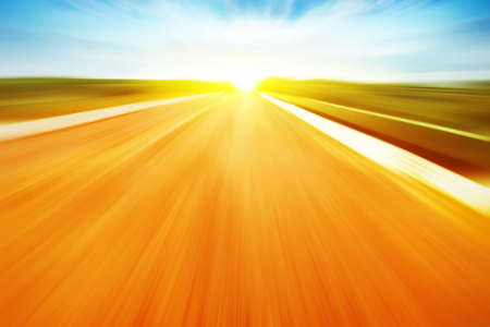 Country asphalt road in motion blur at sunset. の写真素材