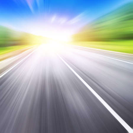 Country asphalt road in motion blur at sunset.の写真素材