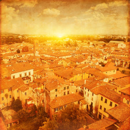 Grunge image of Lucca at sunset, old town in Tuscany. Italy.の写真素材