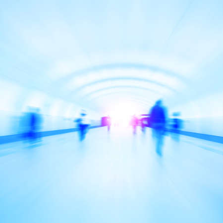 Abstract image of motion blurred people walking in subway station.の写真素材